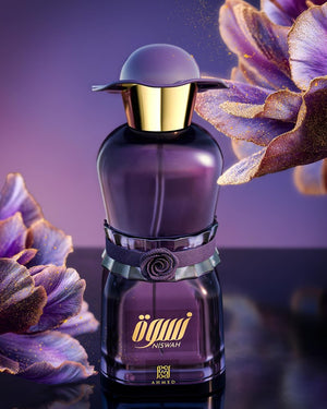 Purple perfume bottle with gold cap on a dark background with purple flowers
