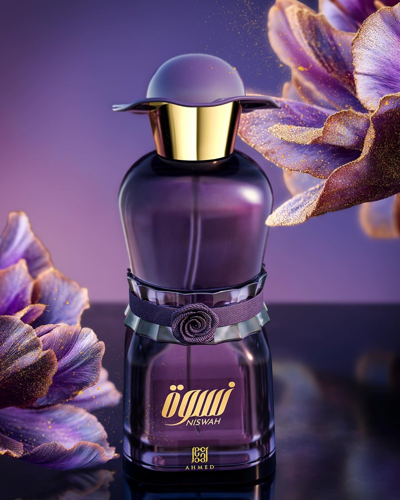 Purple perfume bottle with gold cap on a dark background with purple flowers